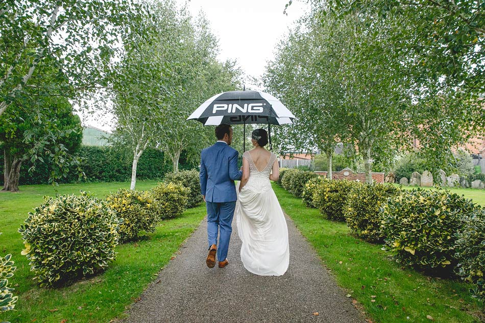 bride and groom in rain