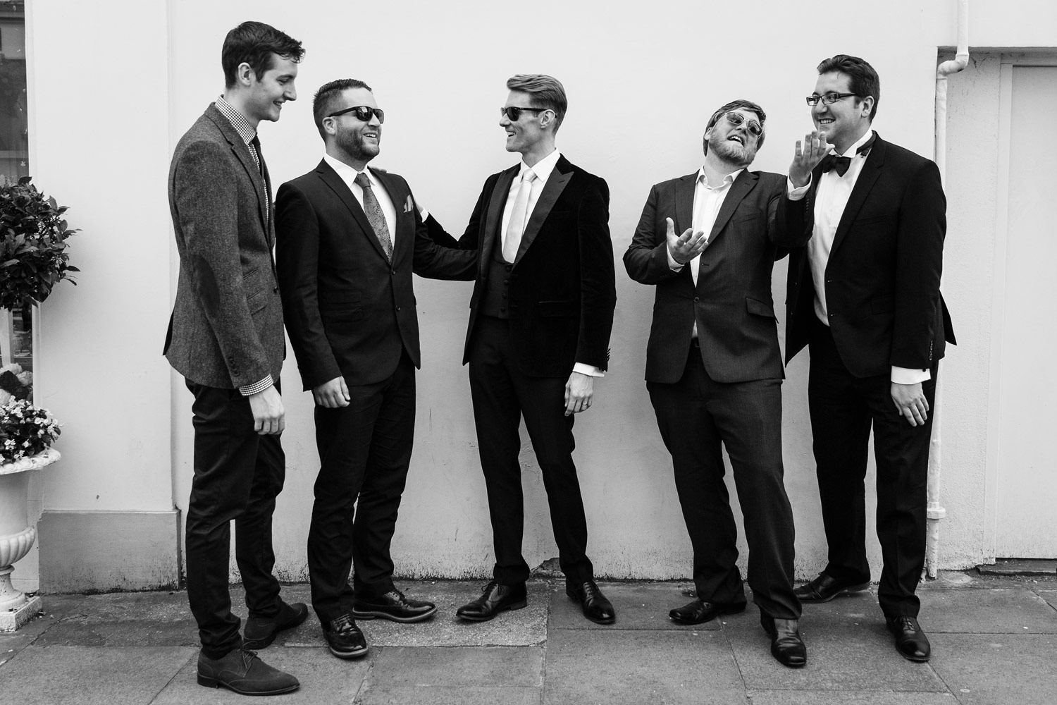 A groom poses with his groomsmen at the Roof Gardens in Kensington - London wedding photographer