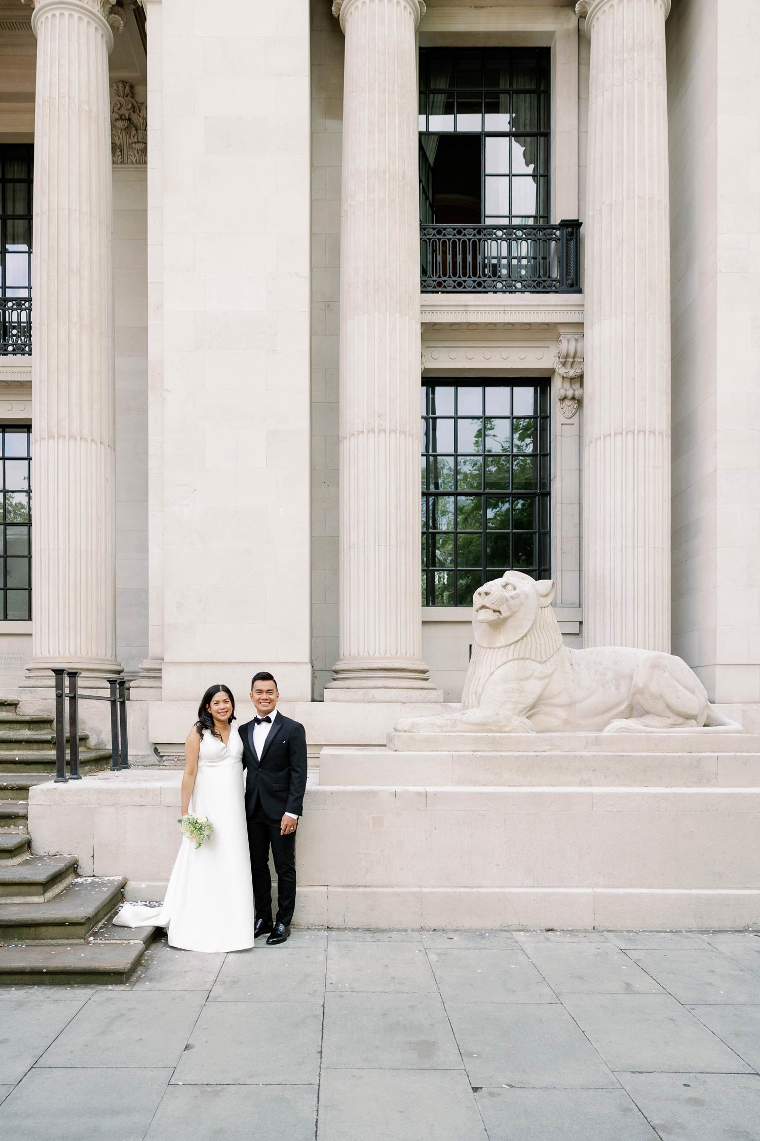 A couple stand outside the Old Marylebone Town Hall for their London micro wedding