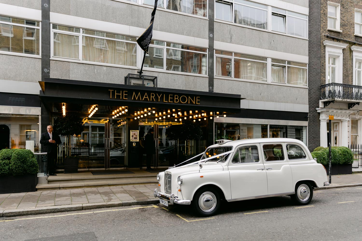 A bridal car waits outside the Marylebone Hotel
