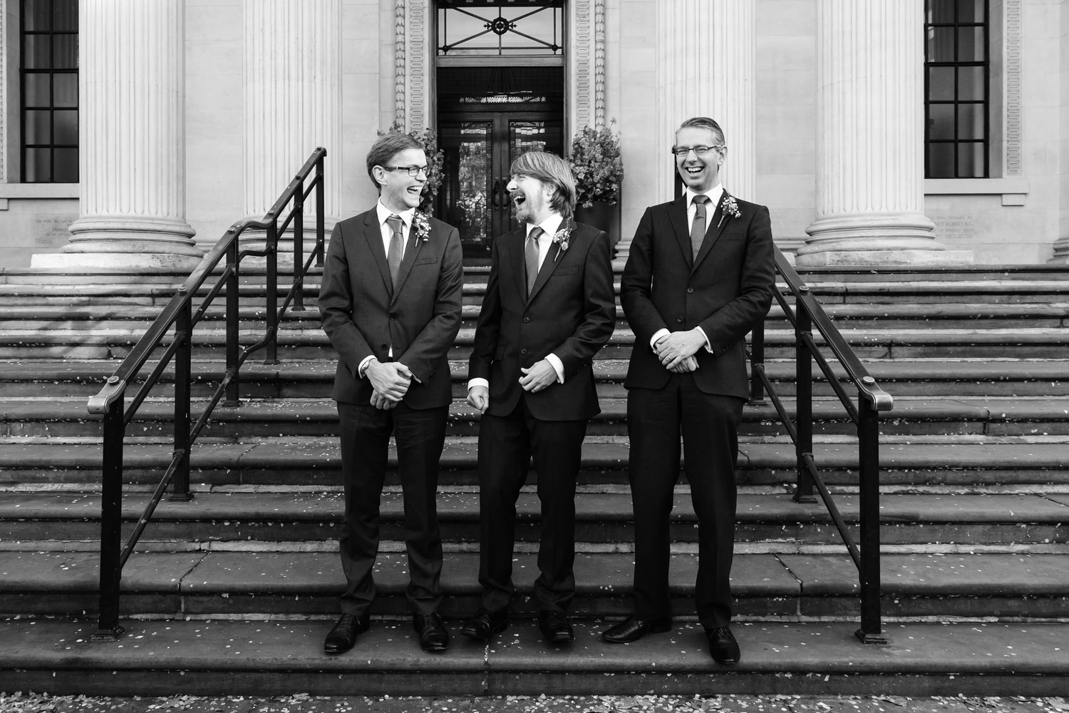 A groom and his groomsmen pose on the steps of Old Marylebone Town Hall