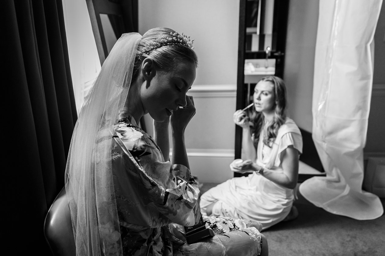 A bride gets her hair and make up done at the Ampersand Hotel - London wedding photographer - Black and white photograph